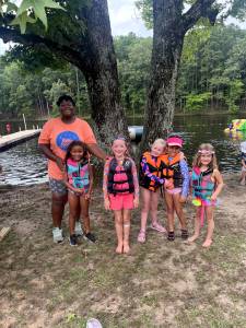 group of campers with counselor by lake nixon at camp